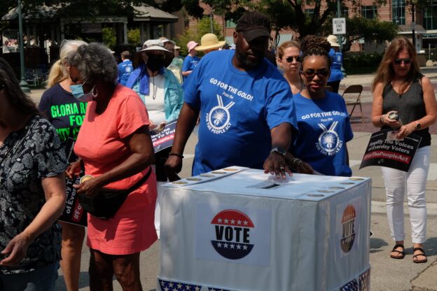 People cast their votes for federal democracy reform as part of NETWORK’s “Team Democracy” events across the country in 2021. Voting rights, which have come under threat at the state level since the U.S. Supreme Court gutted the Voting Rights Act in 2013, are a key component of NETWORK’s efforts to defend democracy.