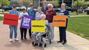 Sisters of St. Joseph and friends, pose with Erie, PA Mayor Joe Schember at the Care Not Cuts Rally in Erie, PA