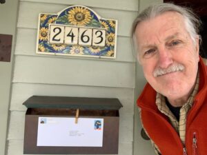 Bob Kloos at his mailbox with a letter addressed to the White House