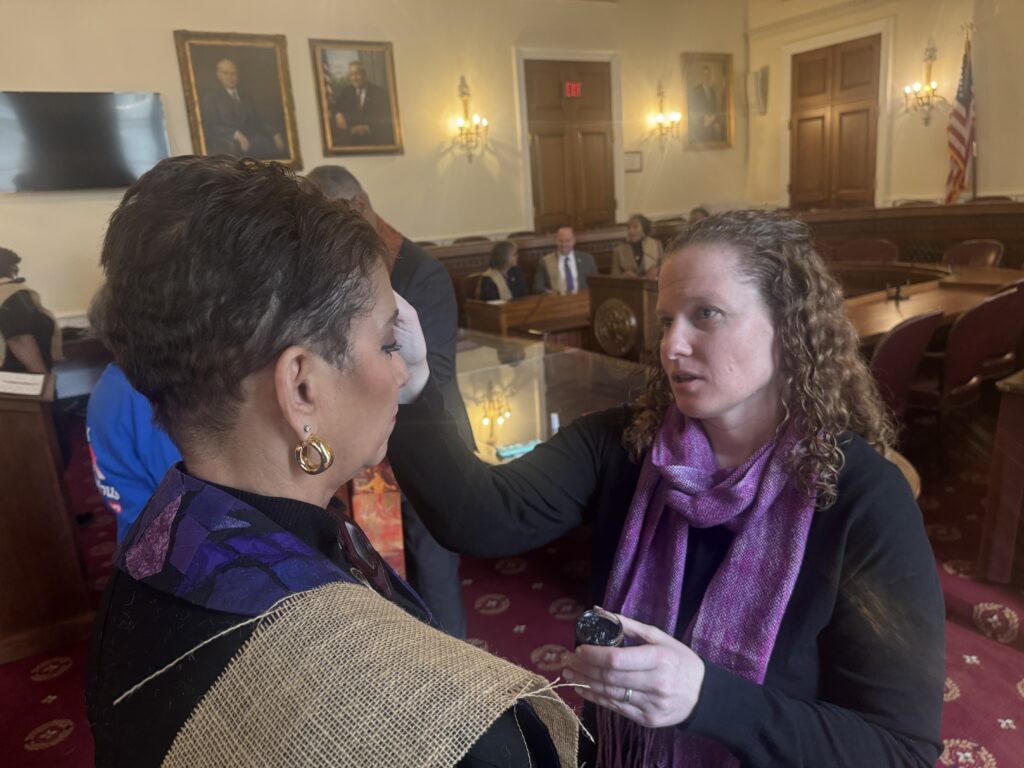 Sr. Erin Zubal, OSU, NETWORK Chief of Staff, distributes ashes at the March 5 prayer service for a compassionate budget on Capitol Hill.