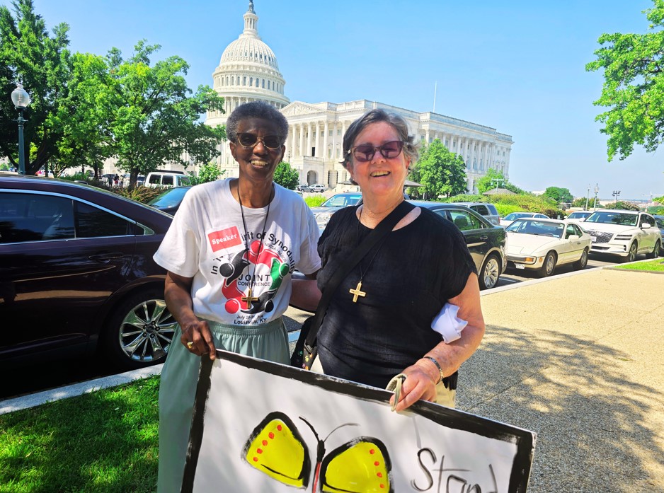 Sr. Patty Chappell andSr. Ann Howard, SNDdeN hold a sign at the June 24 Sisters Speak Out event on Capitol Hill.
