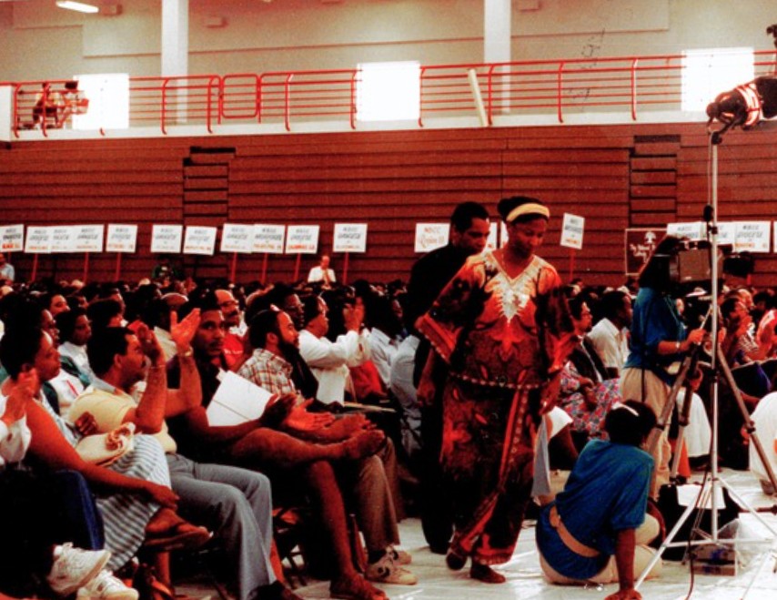 Sr. Thea Bowman walks past future NETWORK Fellow Ralph McCloud at a gathering of Black Catholics in the 1980s.