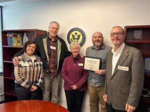 Four members of the Ohio Advocates Team stand with a staffer from Rep. Shontel Borwn's office.
