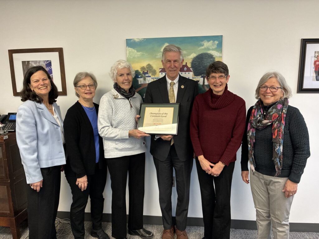 Laura Peralta-Schulte, Peg Butner, Anne Murphy, Paula Cruickshank, and Nancy McBride present a 100 percent certificate to Rep. Don Beyer (VA-08) for hisperfect score on NETWORK’s 2025 Voting Record.